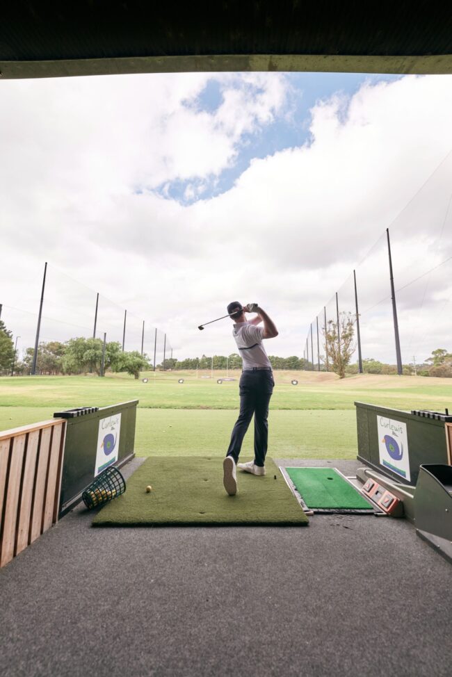 Curlewis_Range_Driving Range man on a driving range hitting a golf ball